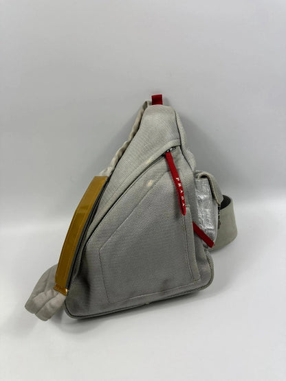 Prada grey sling bag with silver mesh and patent leather, featuring a collector's design.