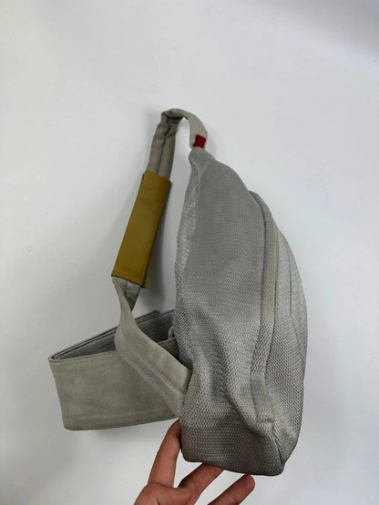 Prada grey sling bag with silver mesh and patent leather, featuring a collector's design.