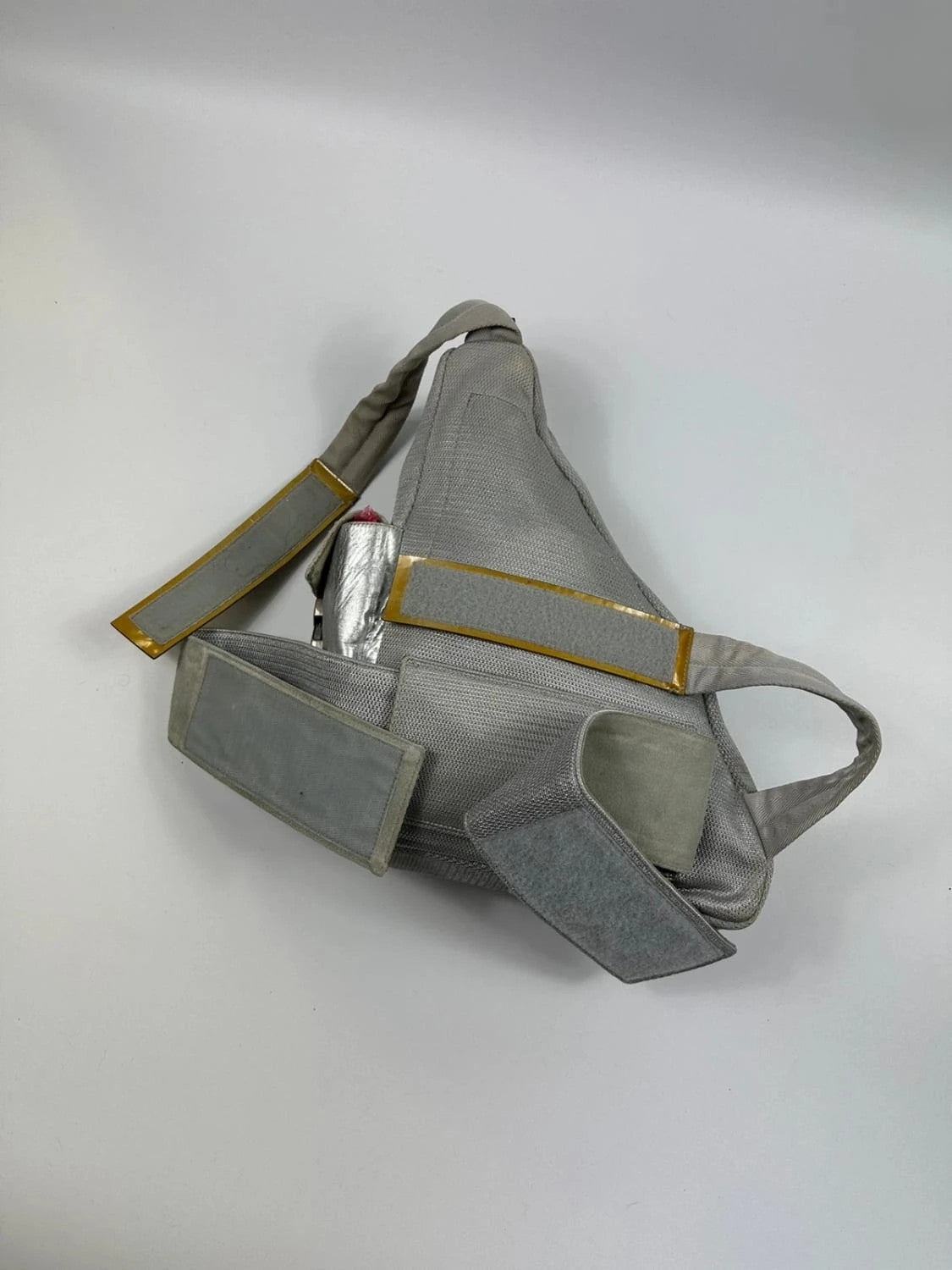 Prada grey sling bag with silver mesh and patent leather, featuring a collector's design.