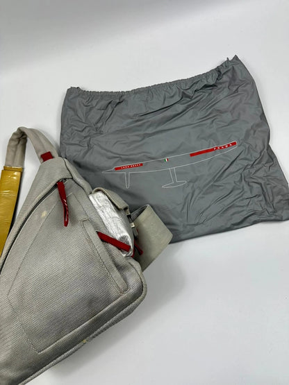 Prada grey sling bag with silver mesh and patent leather, featuring a collector's design.