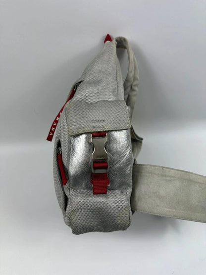 Prada grey sling bag with silver mesh and patent leather, featuring a collector's design.