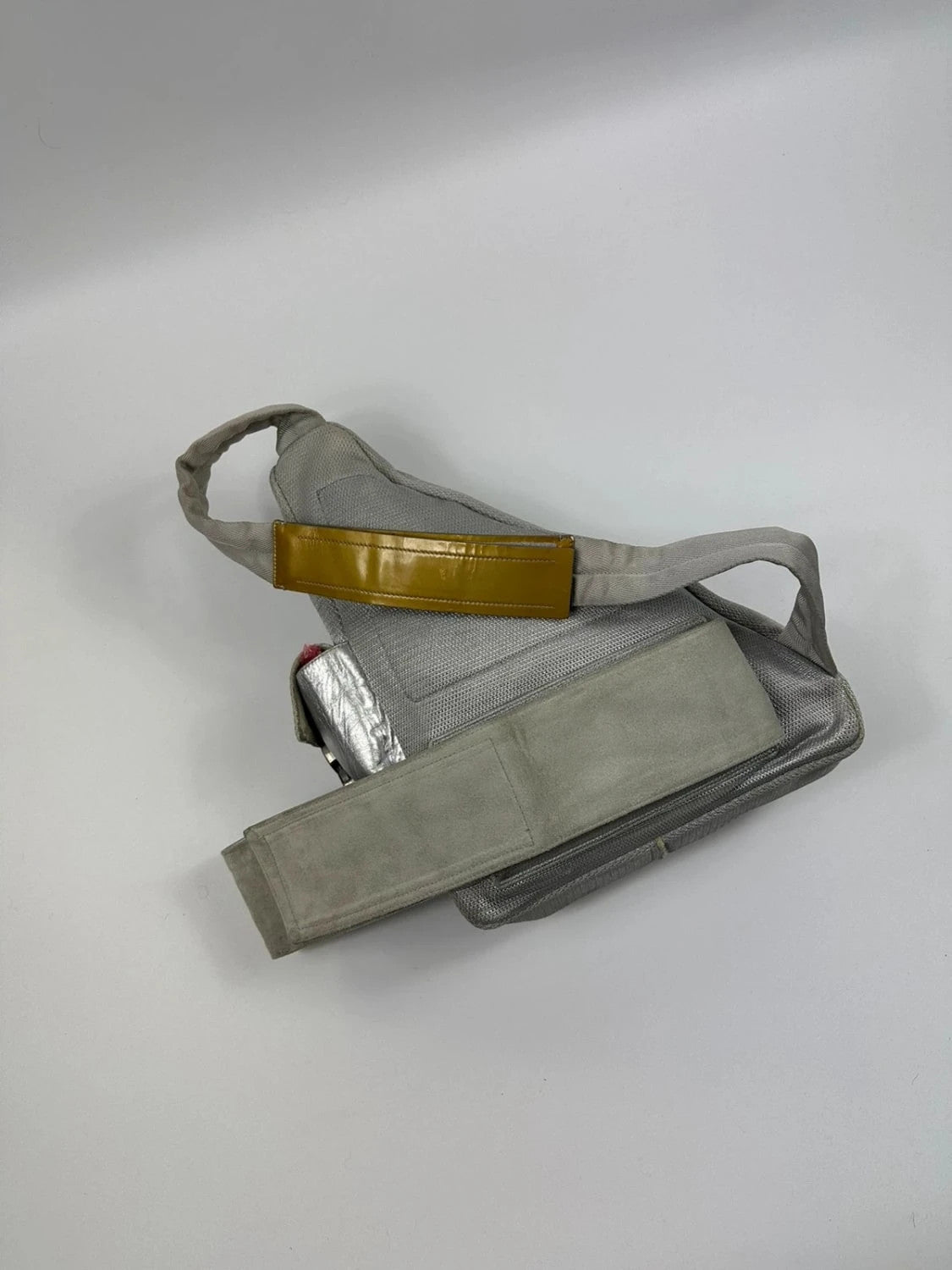 Prada grey sling bag with silver mesh and patent leather, featuring a collector's design.