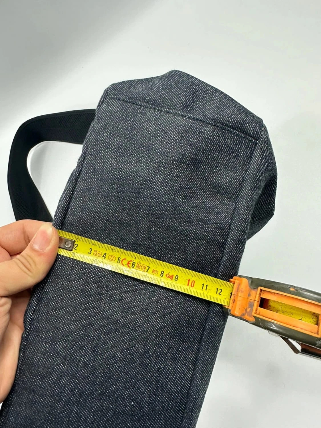 Miu Miu 90s denim crossbody sling bag in black and grey with logo detail.