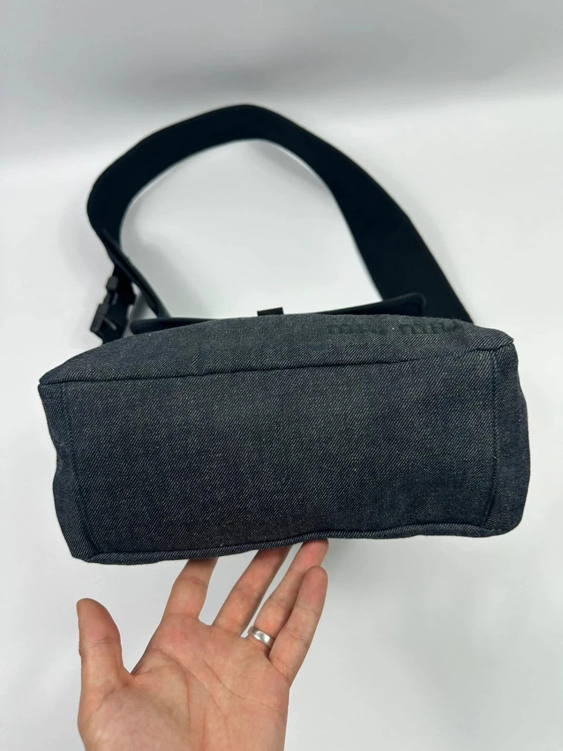 Miu Miu 90s denim crossbody sling bag in black and grey with logo detail.