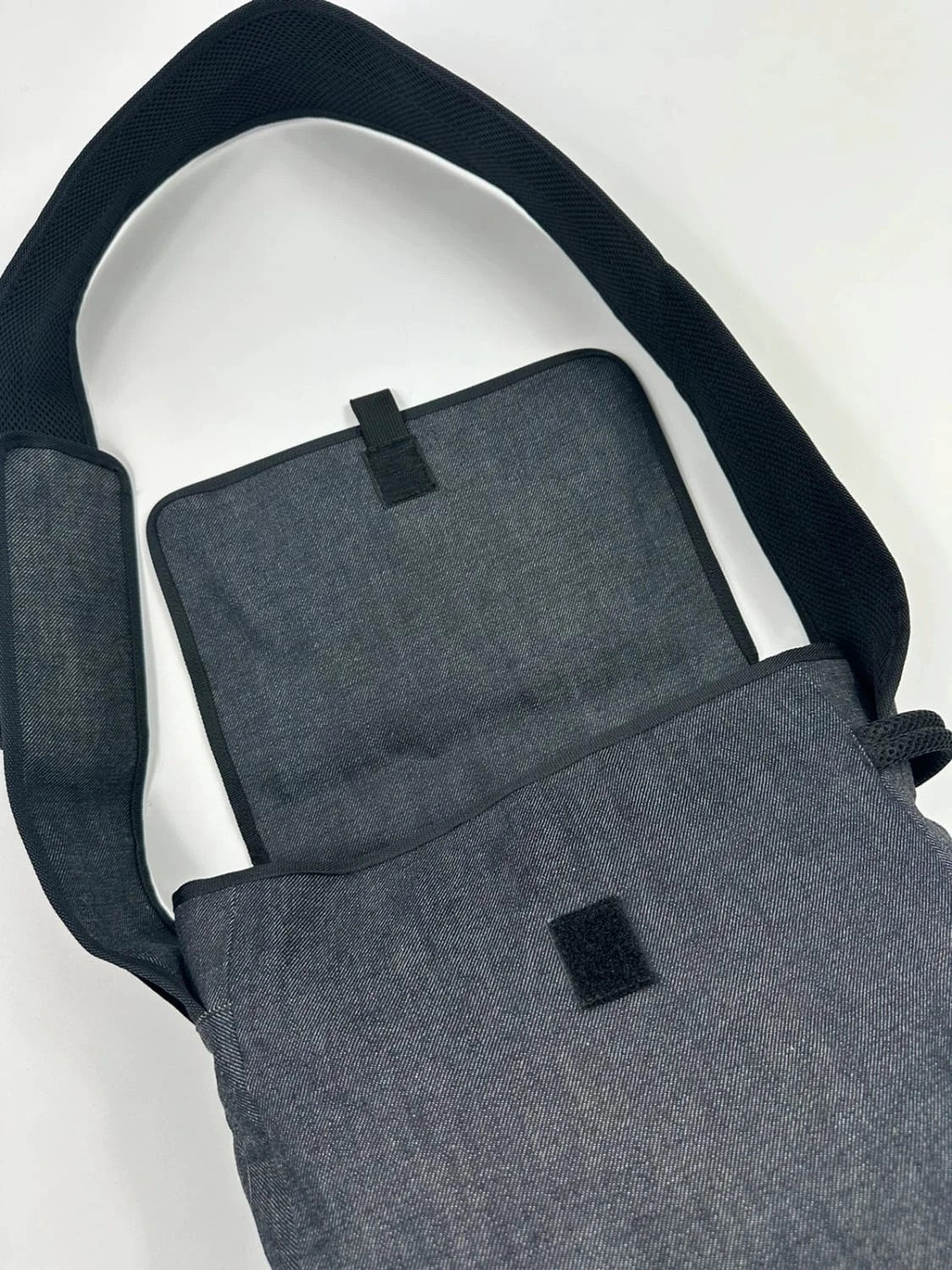 Miu Miu 90s denim crossbody sling bag in black and grey with logo detail.