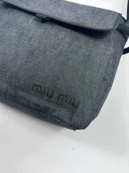 Miu Miu 90s denim crossbody sling bag in black and grey with logo detail.