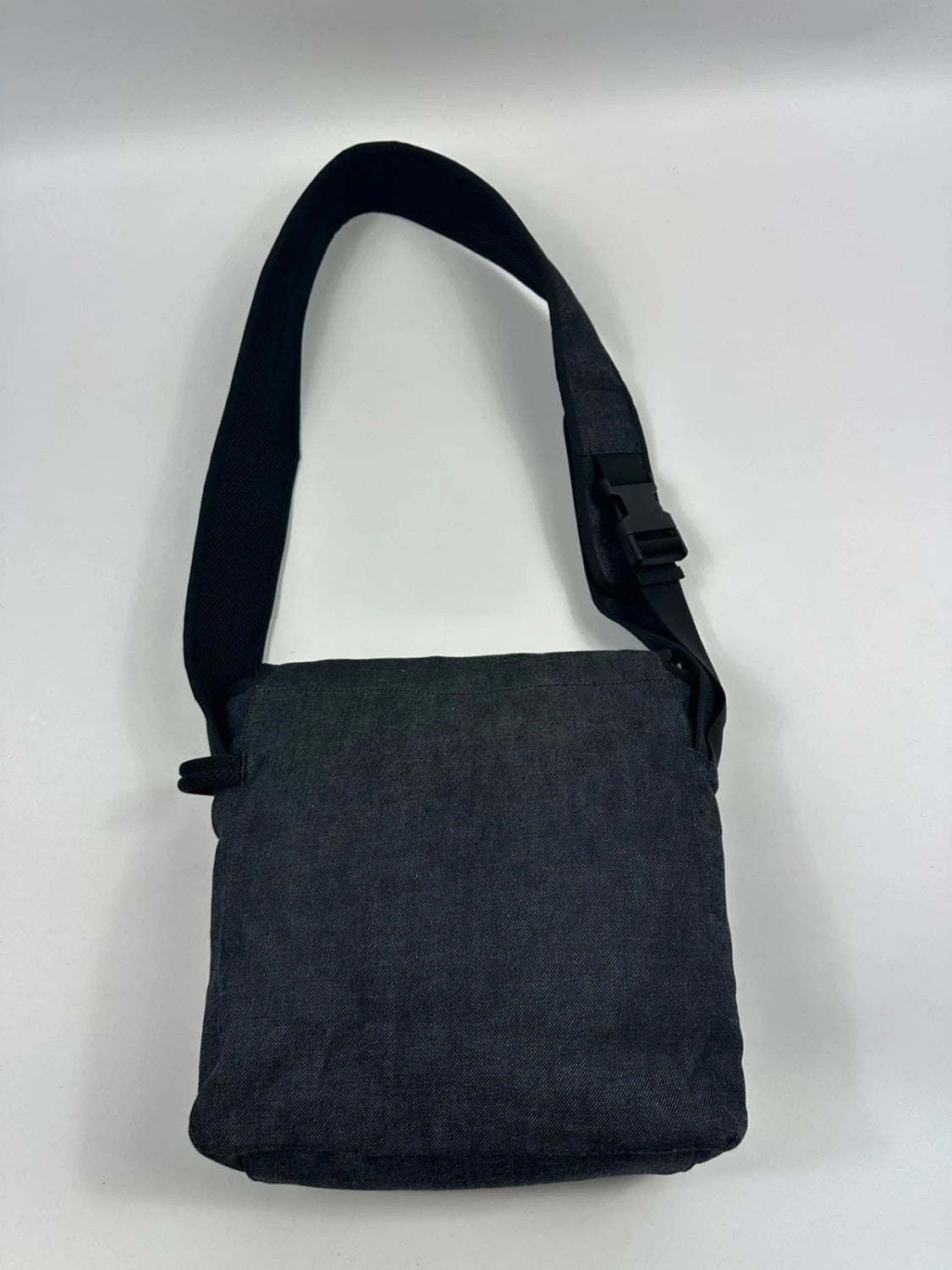 Miu Miu 90s denim crossbody sling bag in black and grey with logo detail.