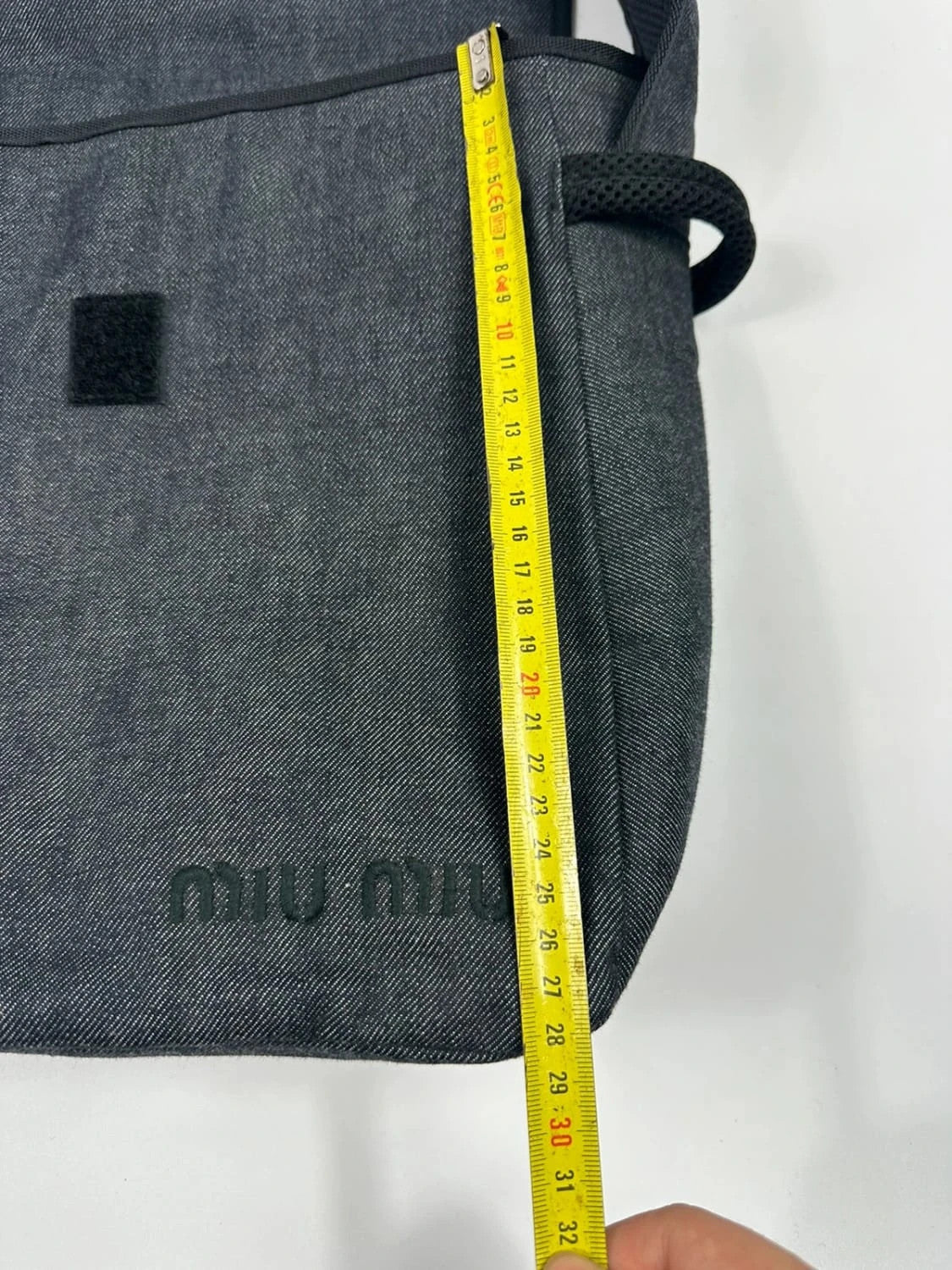Miu Miu 90s denim crossbody sling bag in black and grey with logo detail.