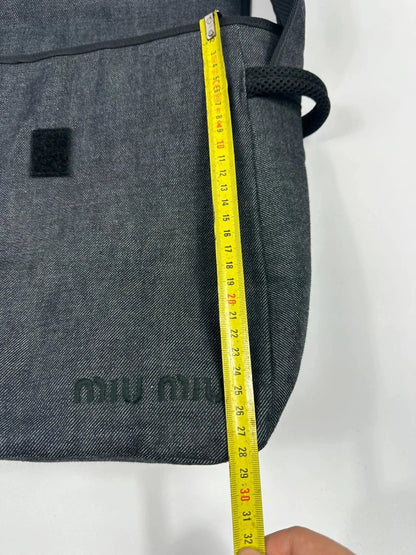 Miu Miu 90s denim crossbody sling bag in black and grey with logo detail.