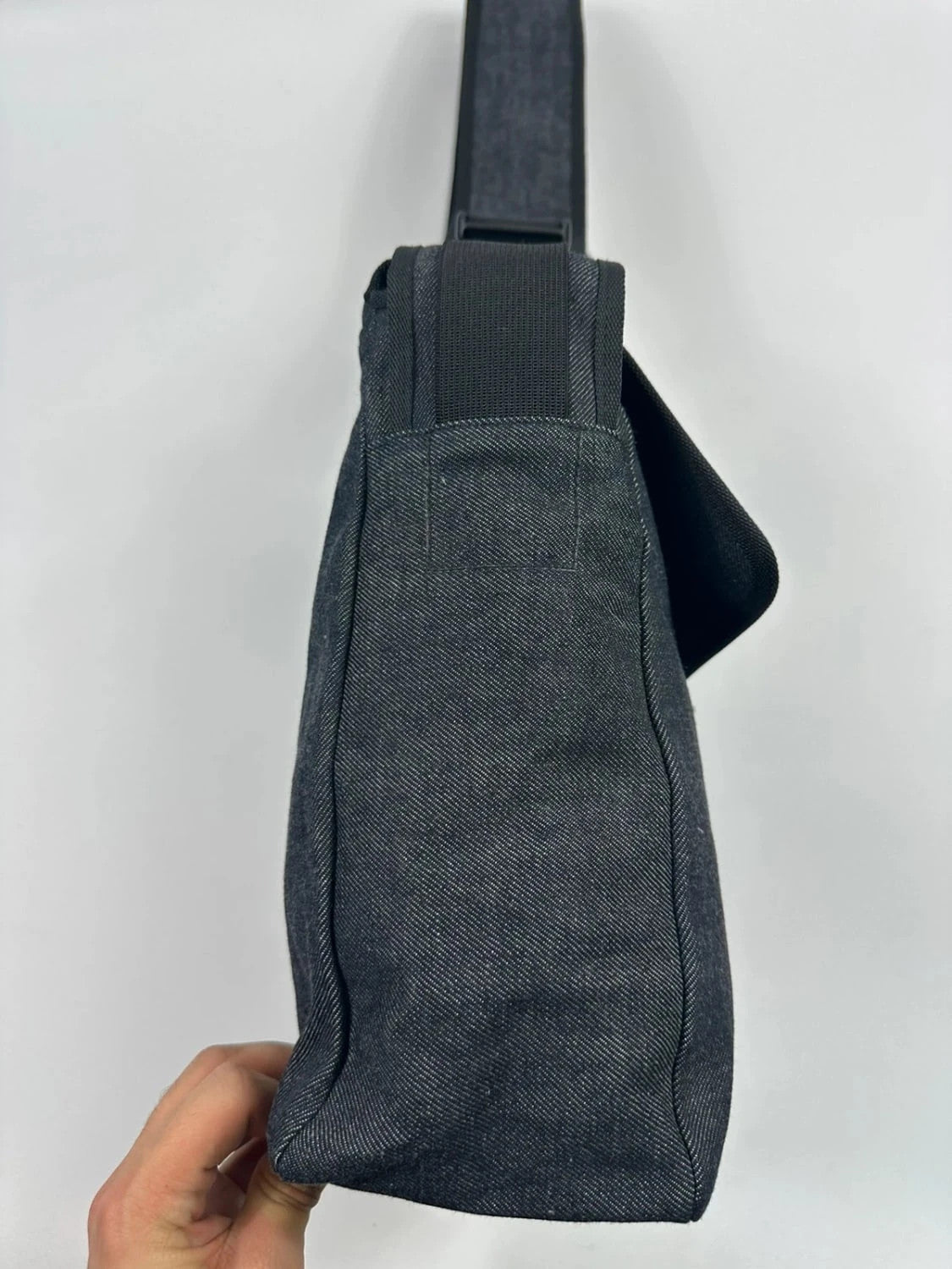 Miu Miu 90s denim crossbody sling bag in black and grey with logo detail.