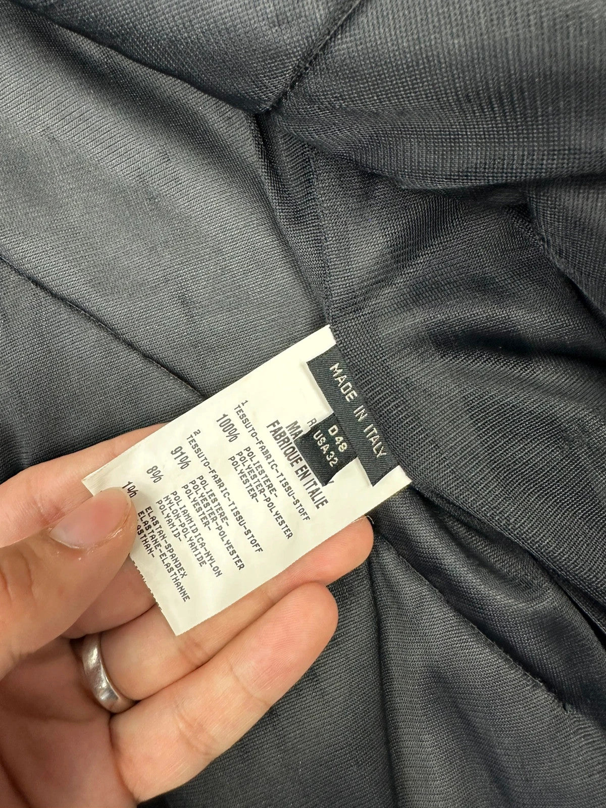 Marithé Francois Girbaud black coat with white utility stitching and logo details.