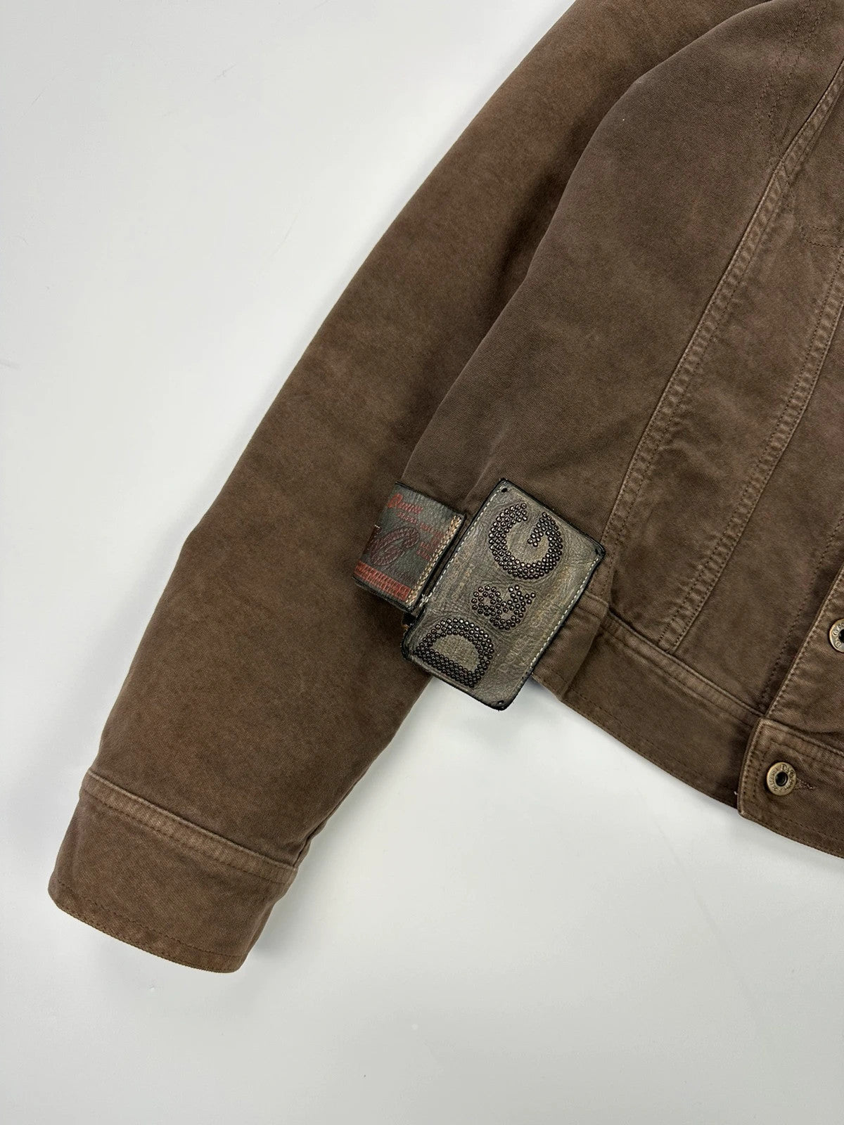 Dolce & Gabbana brown jacket with patch tags and vintage 2003 runway details.