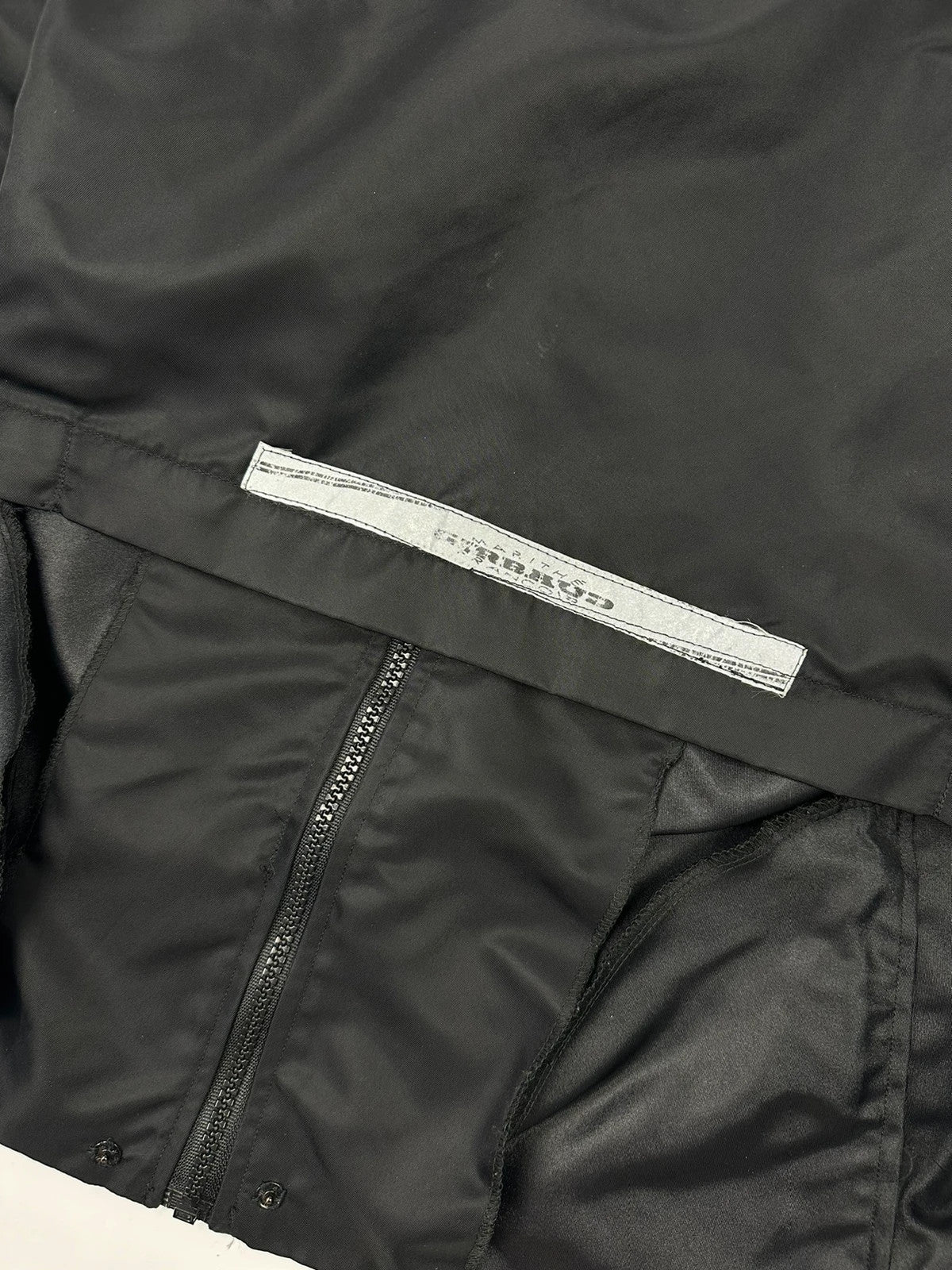 Marithé François Girbaud black nylon crop jacket with open back detail and vintage 90's style.