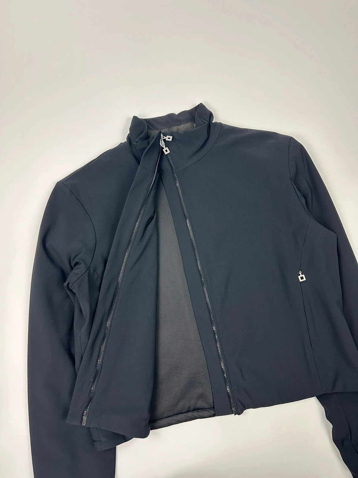 Marithé François Girbaud navy blue padded jacket with logo detailing and minimalist design.