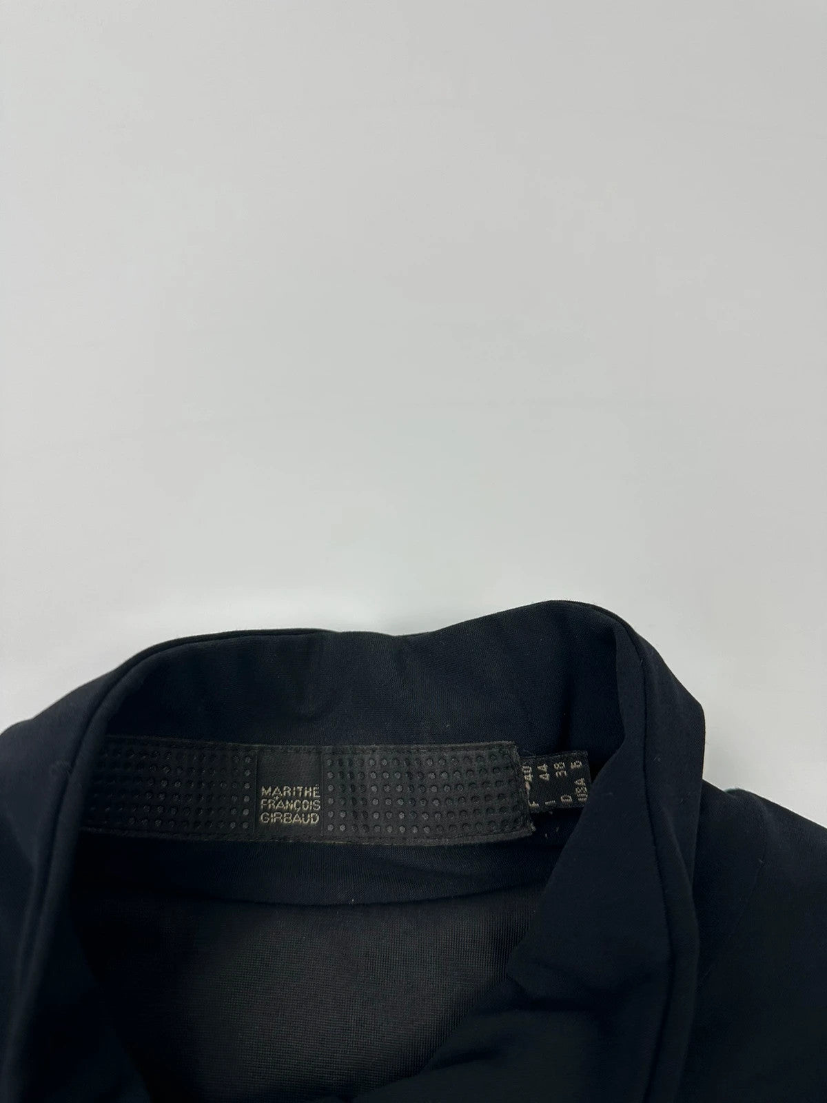 Marithé François Girbaud navy blue padded jacket with logo detailing and minimalist design.