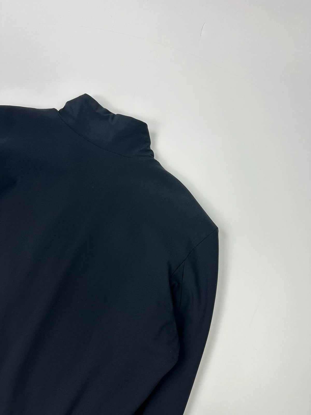 Marithé François Girbaud navy blue padded jacket with logo detailing and minimalist design.