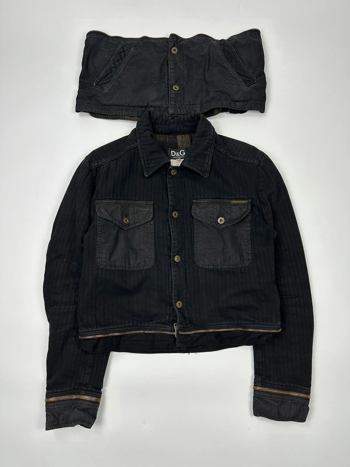 Dolce & Gabbana black denim jacket with detachable features and logo detailing.