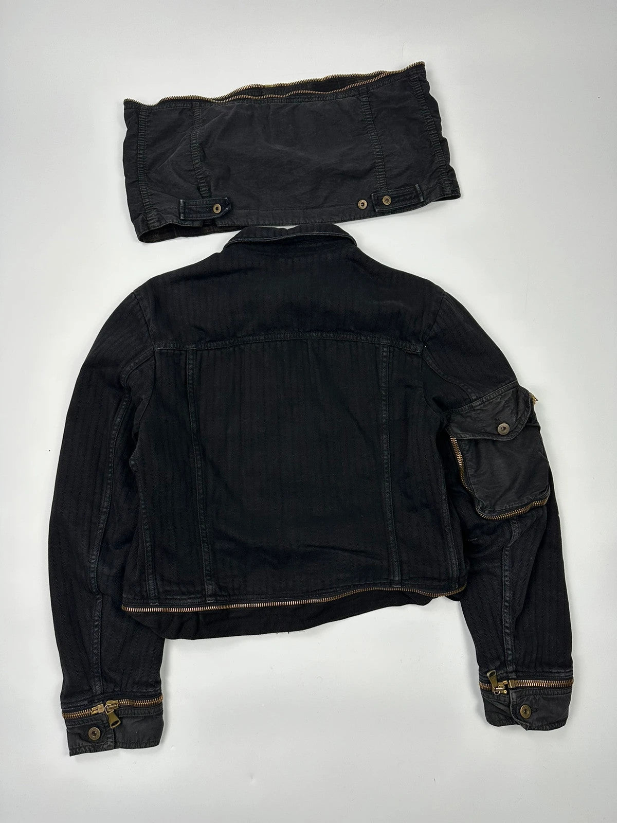 Dolce & Gabbana black denim jacket with detachable features and logo detailing.