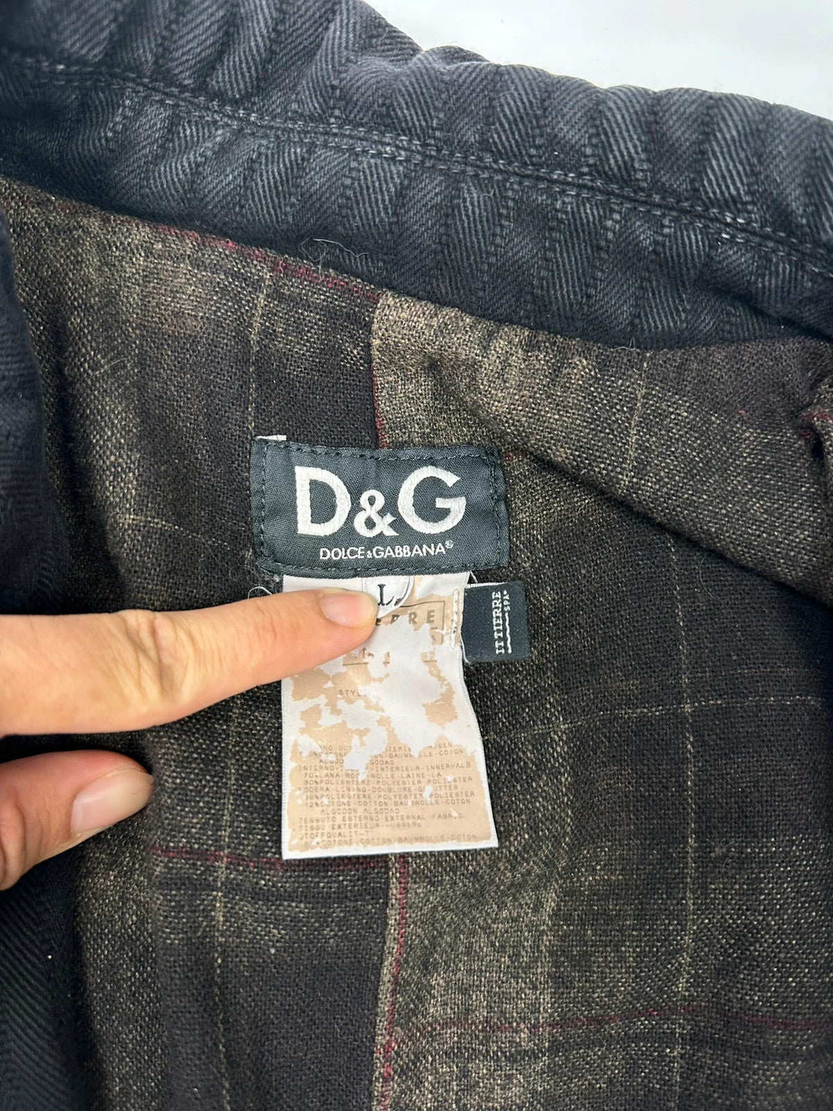 Dolce & Gabbana black denim jacket with detachable features and logo detailing.