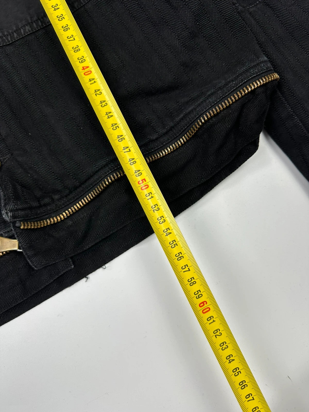 Dolce & Gabbana black denim jacket with detachable features and logo detailing.