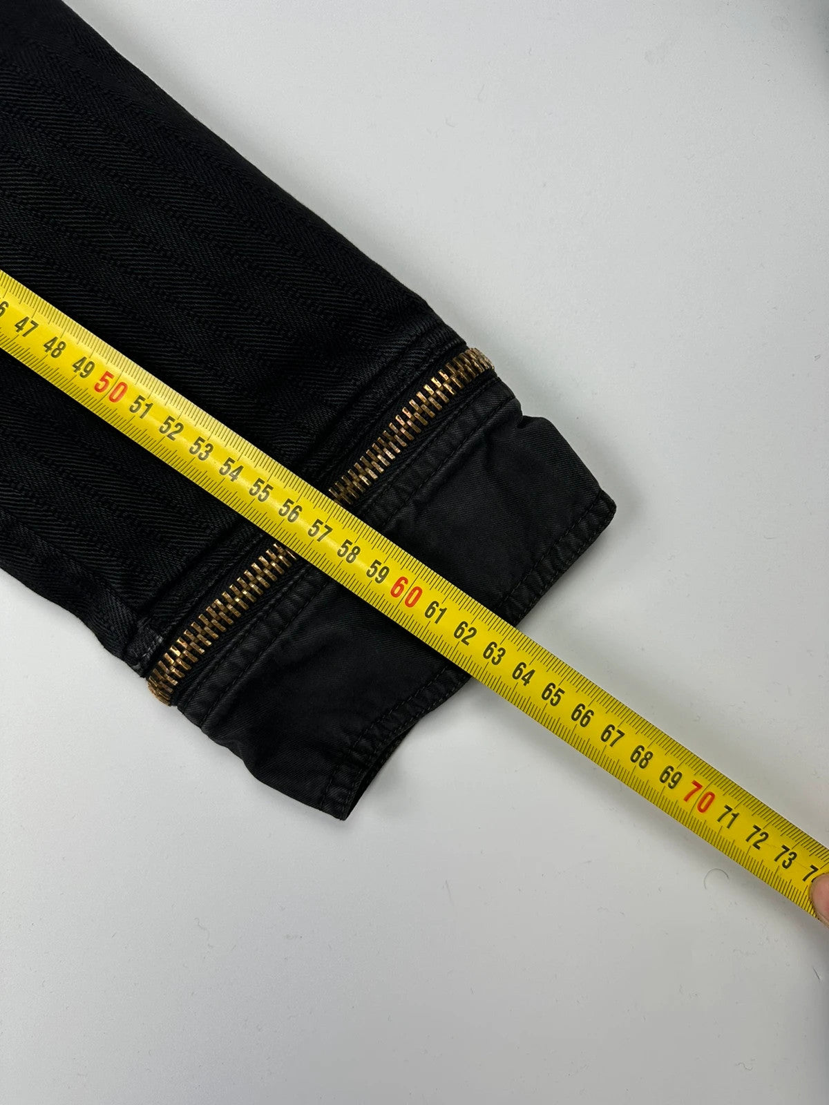 Dolce & Gabbana black denim jacket with detachable features and logo detailing.