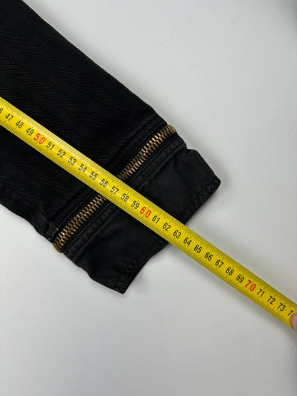 Dolce & Gabbana black denim jacket with detachable features and logo detailing.