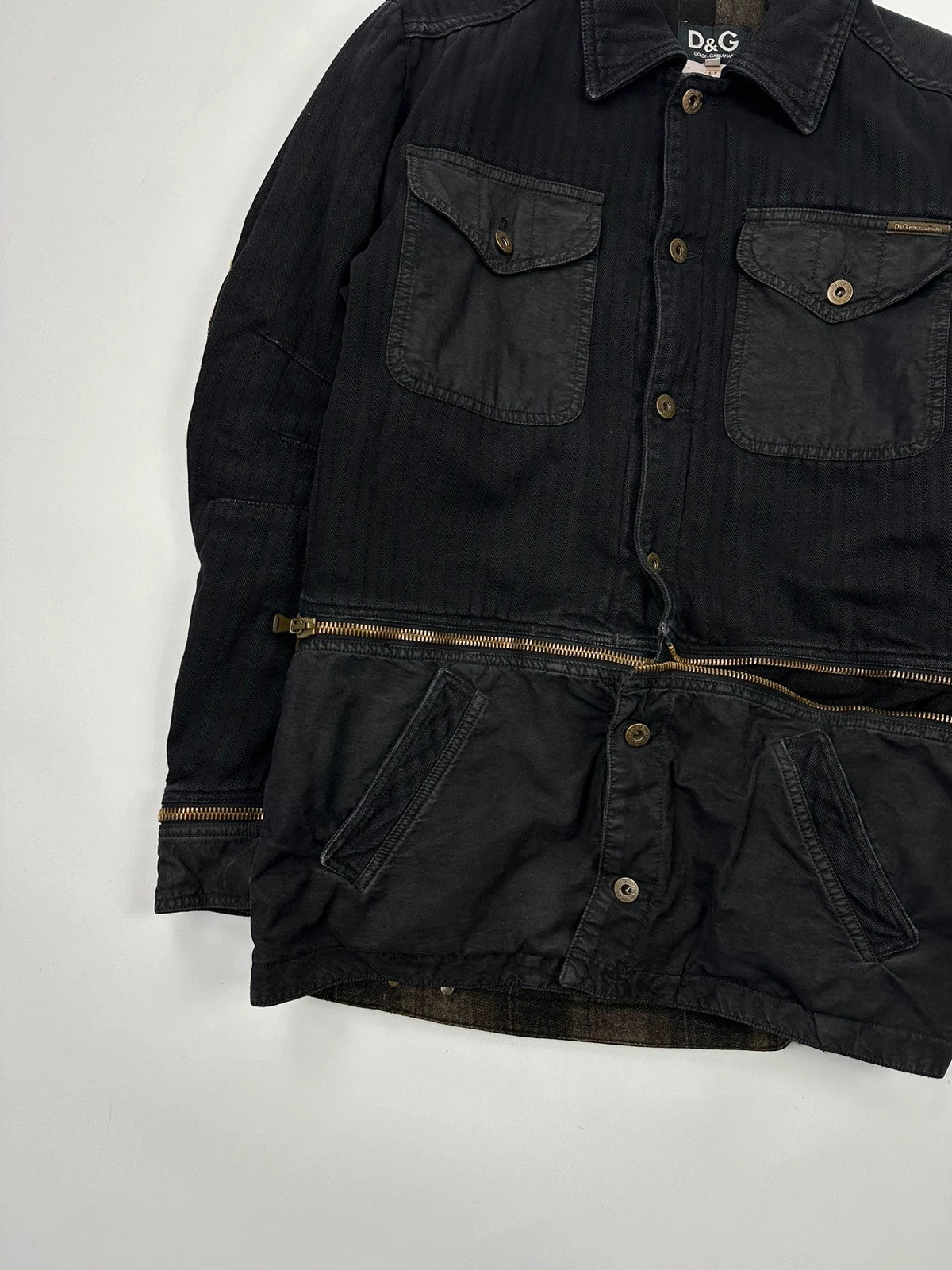 Dolce & Gabbana black denim jacket with detachable features and logo detailing.