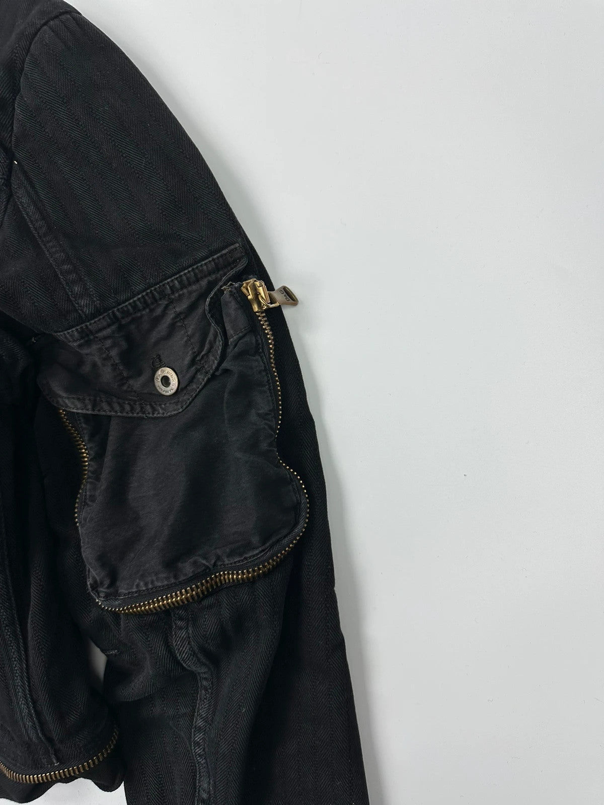 Dolce & Gabbana black denim jacket with detachable features and logo detailing.