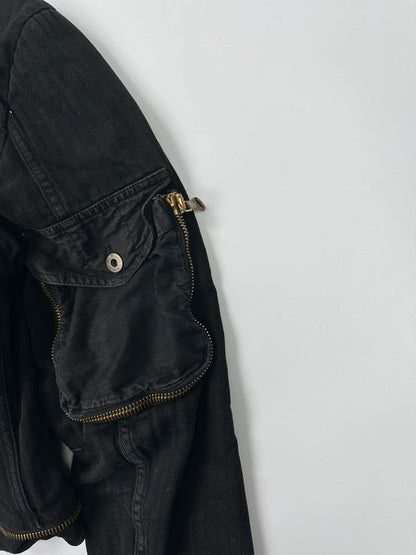 Dolce & Gabbana black denim jacket with detachable features and logo detailing.