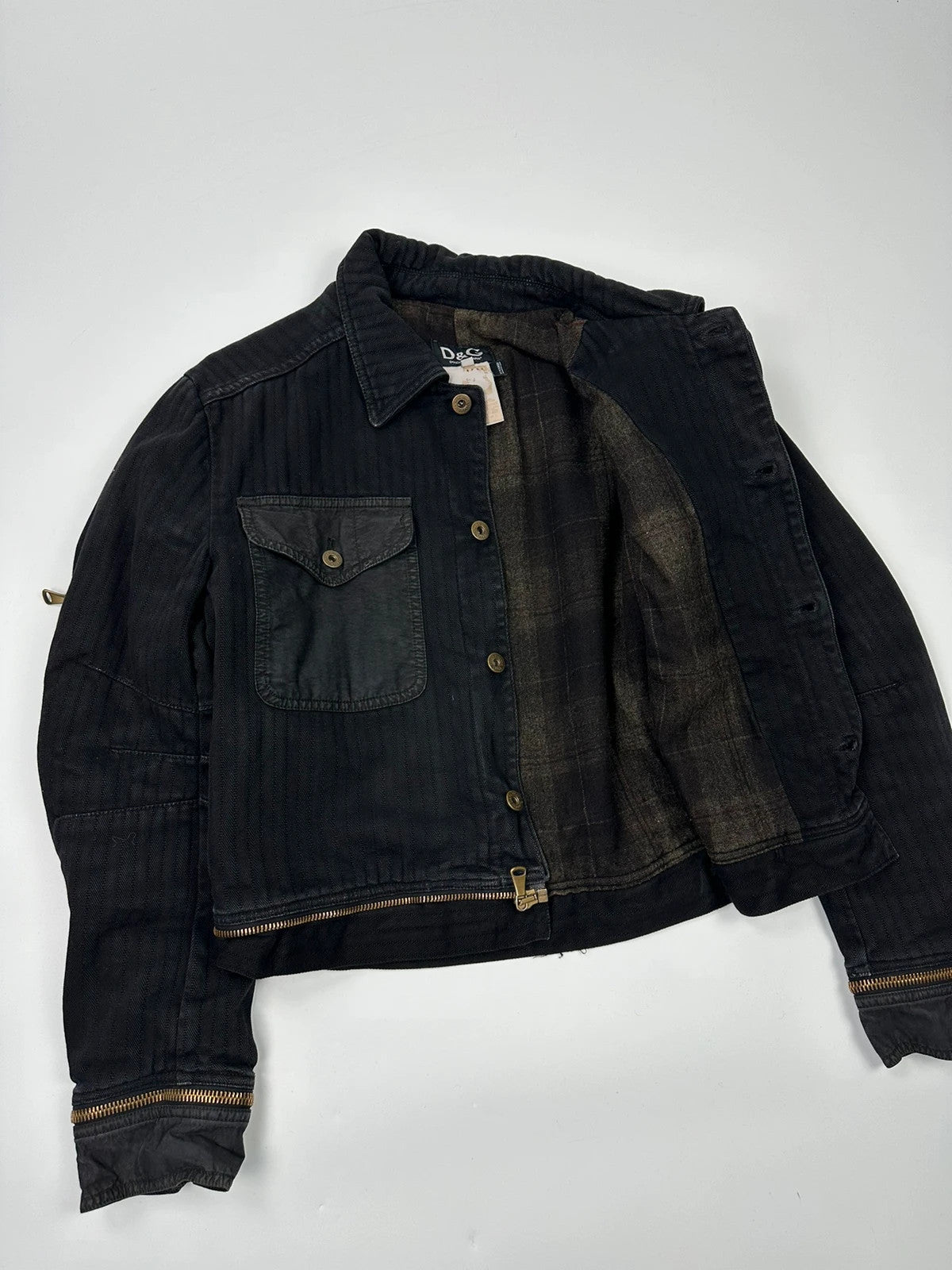 Dolce & Gabbana black denim jacket with detachable features and logo detailing.