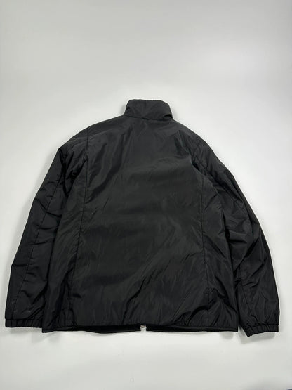 Prada black padded nylon jacket with double zip and minimalist design.