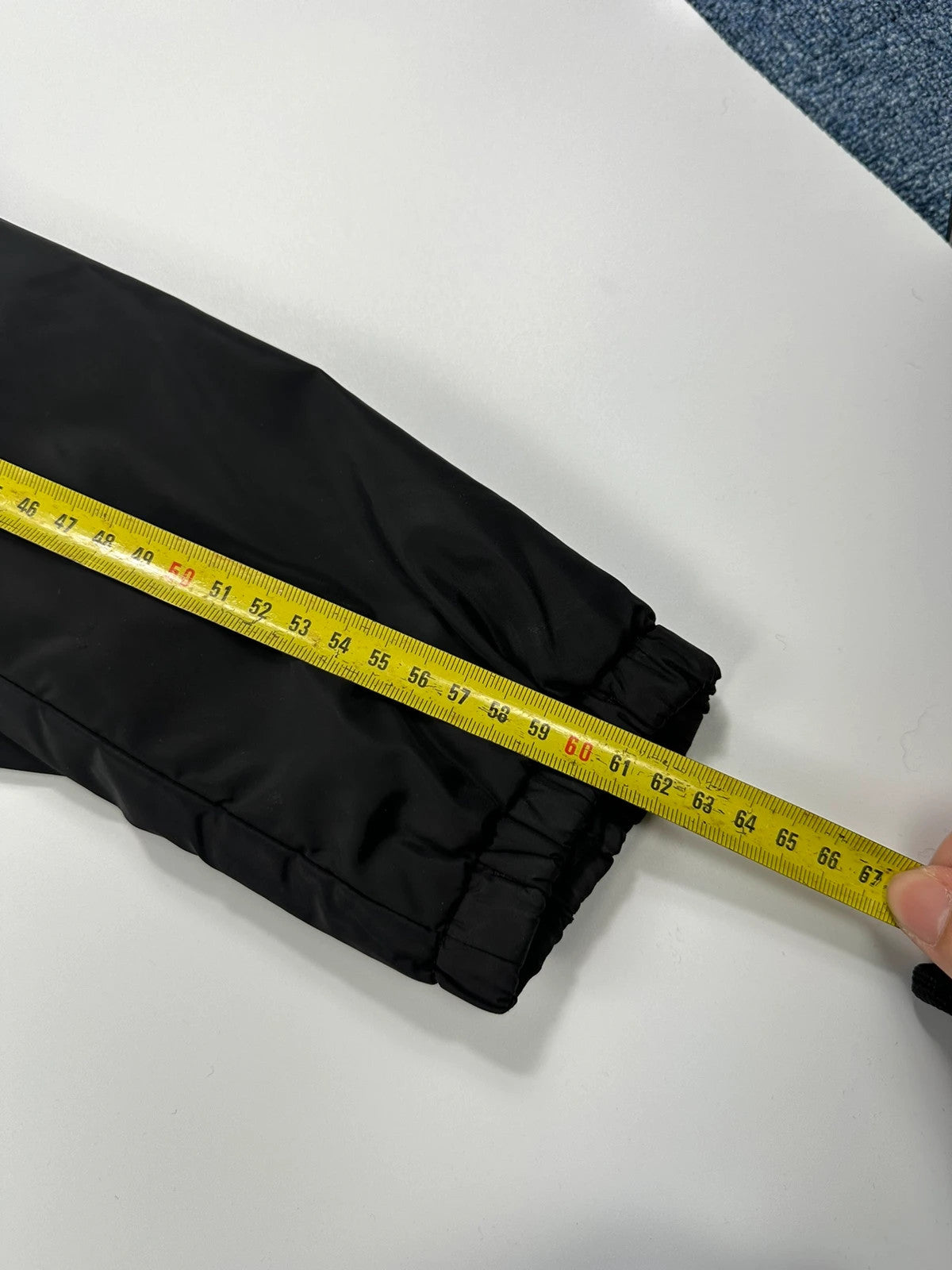 Prada black padded nylon jacket with double zip and minimalist design.