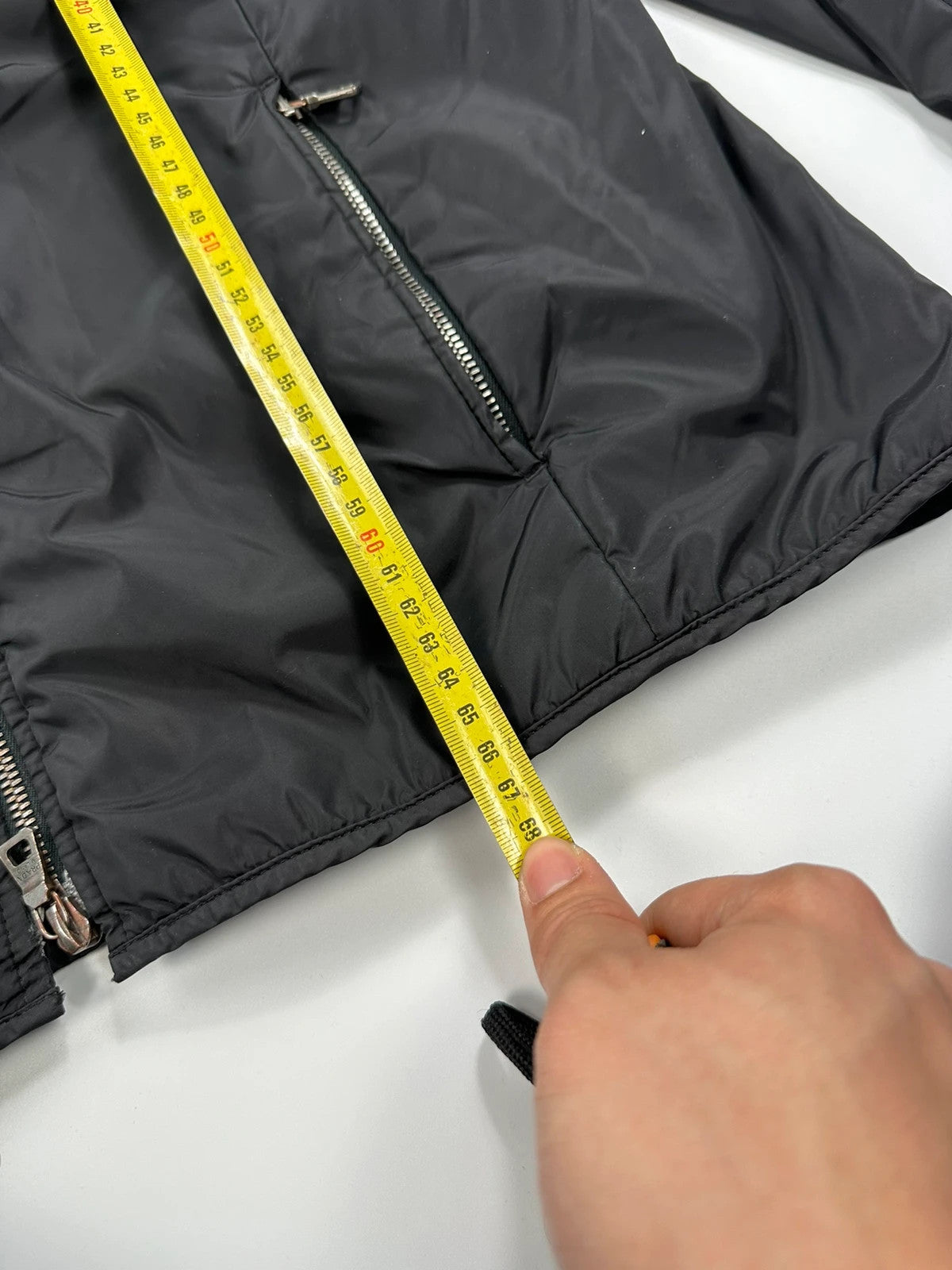 Prada black padded nylon jacket with double zip and minimalist design.