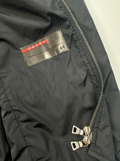 Prada black padded nylon jacket with double zip and minimalist design.