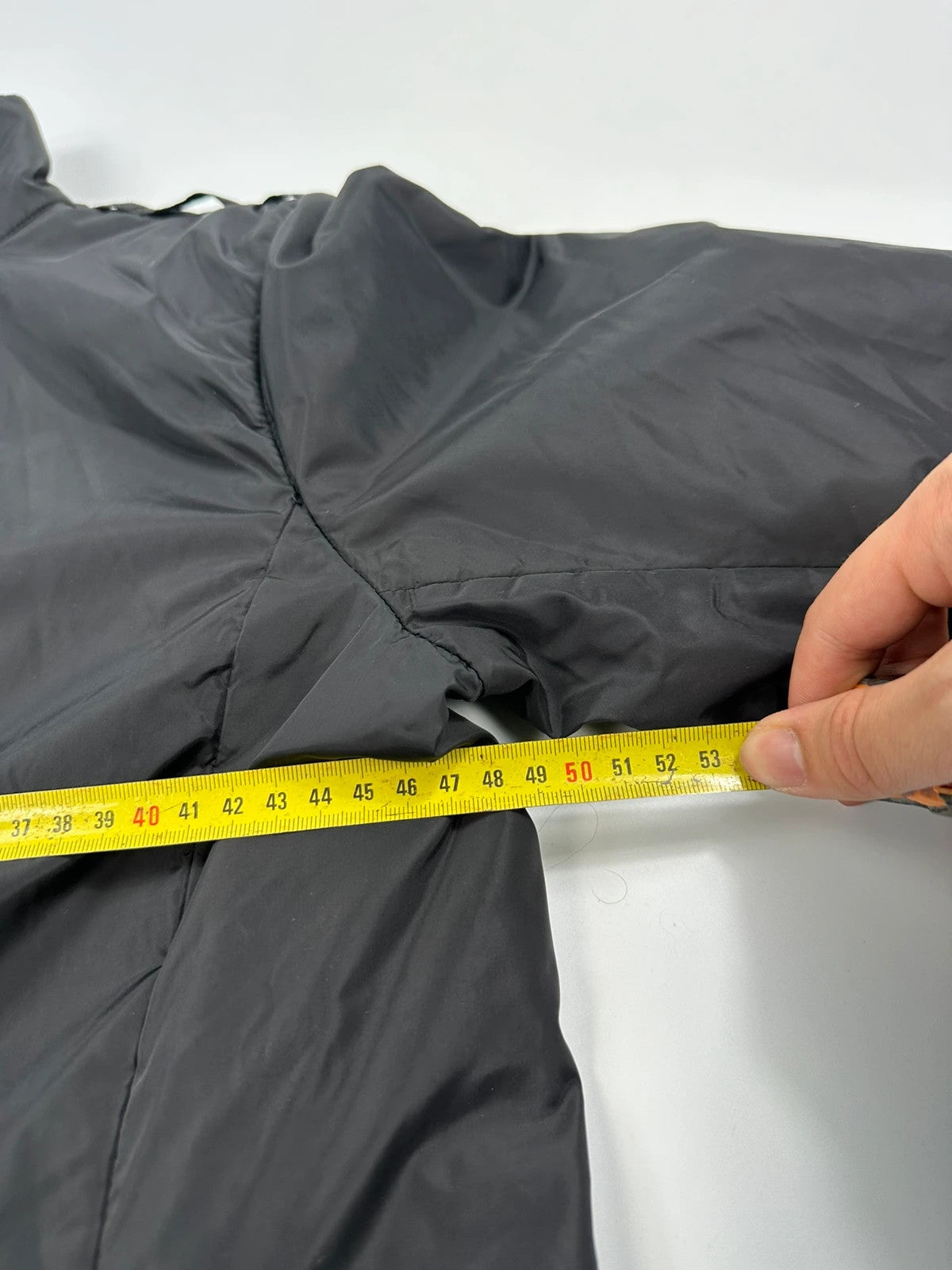 Prada black padded nylon jacket with double zip and minimalist design.