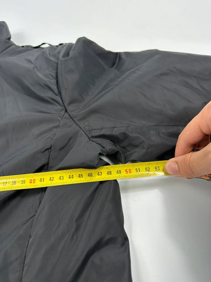 Prada black padded nylon jacket with double zip and minimalist design.