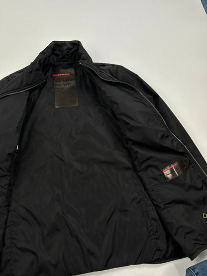 Prada black padded nylon jacket with double zip and minimalist design.