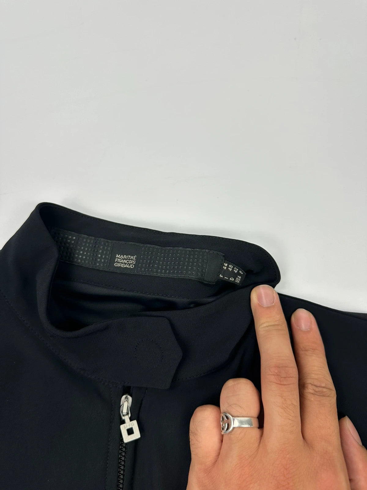 Marithé François Girbaud black fitted jacket with subtle logo detail and sleek design.