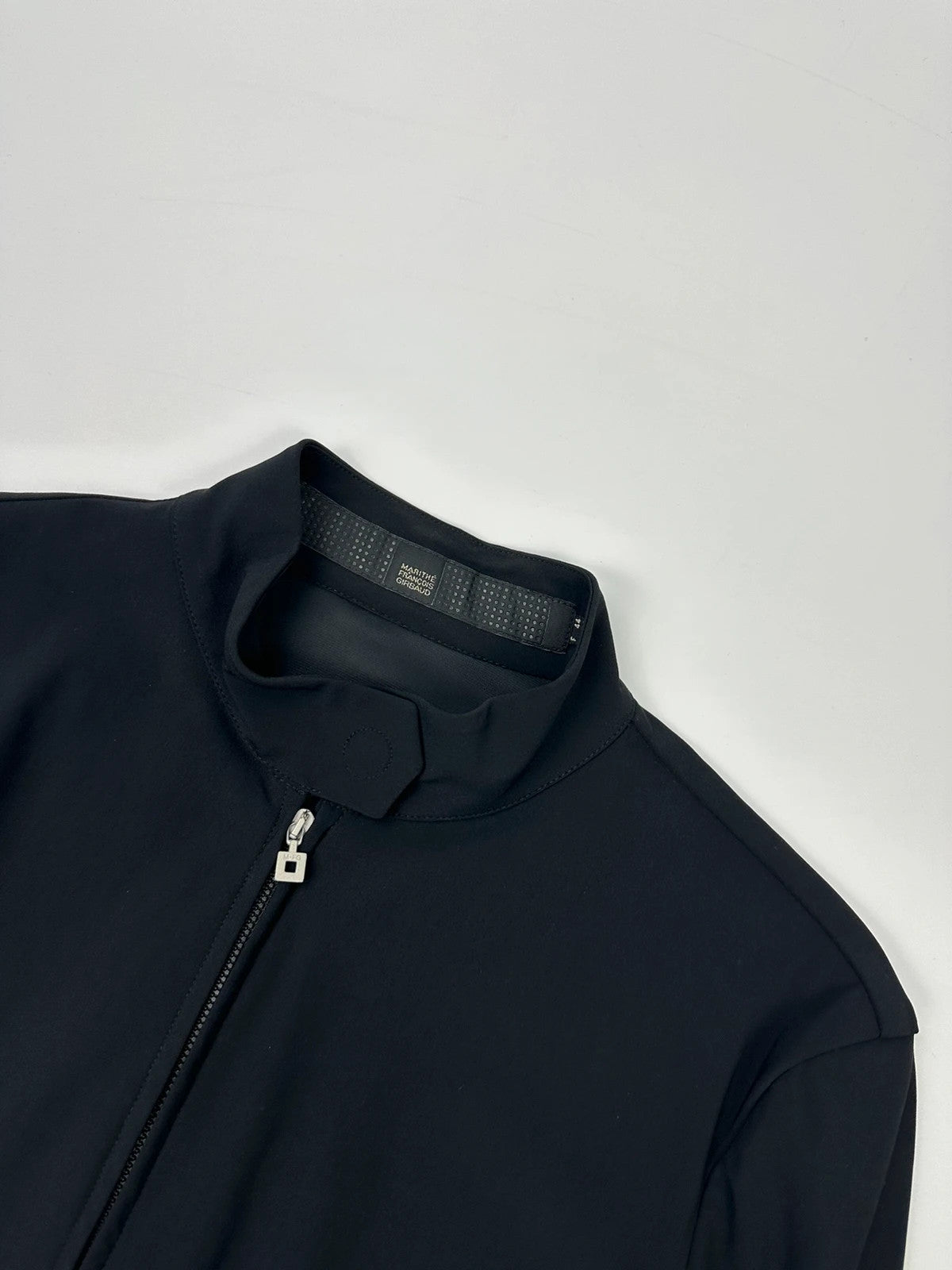 Marithé François Girbaud black fitted jacket with subtle logo detail and sleek design.