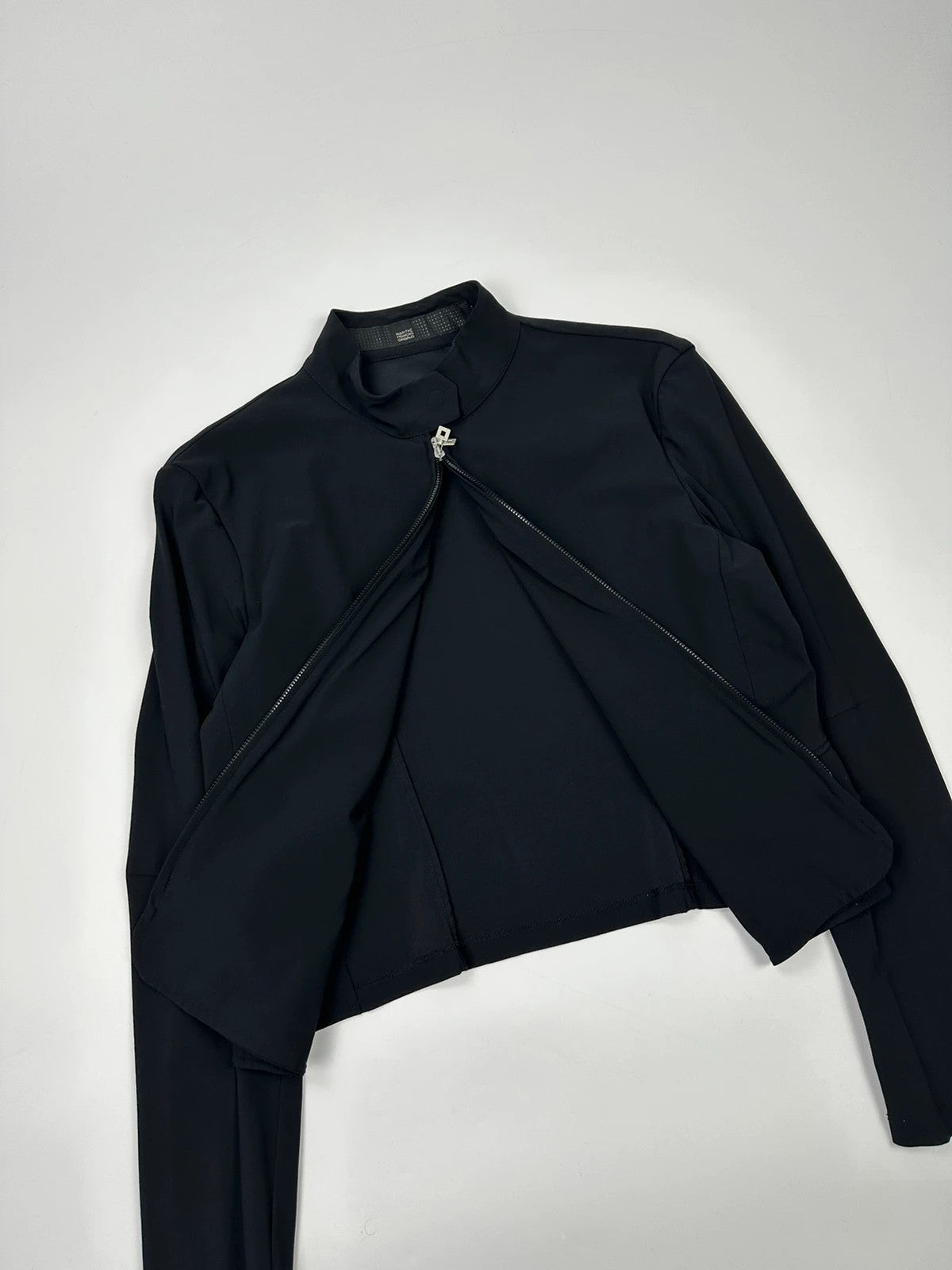 Marithé François Girbaud black fitted jacket with subtle logo detail and sleek design.
