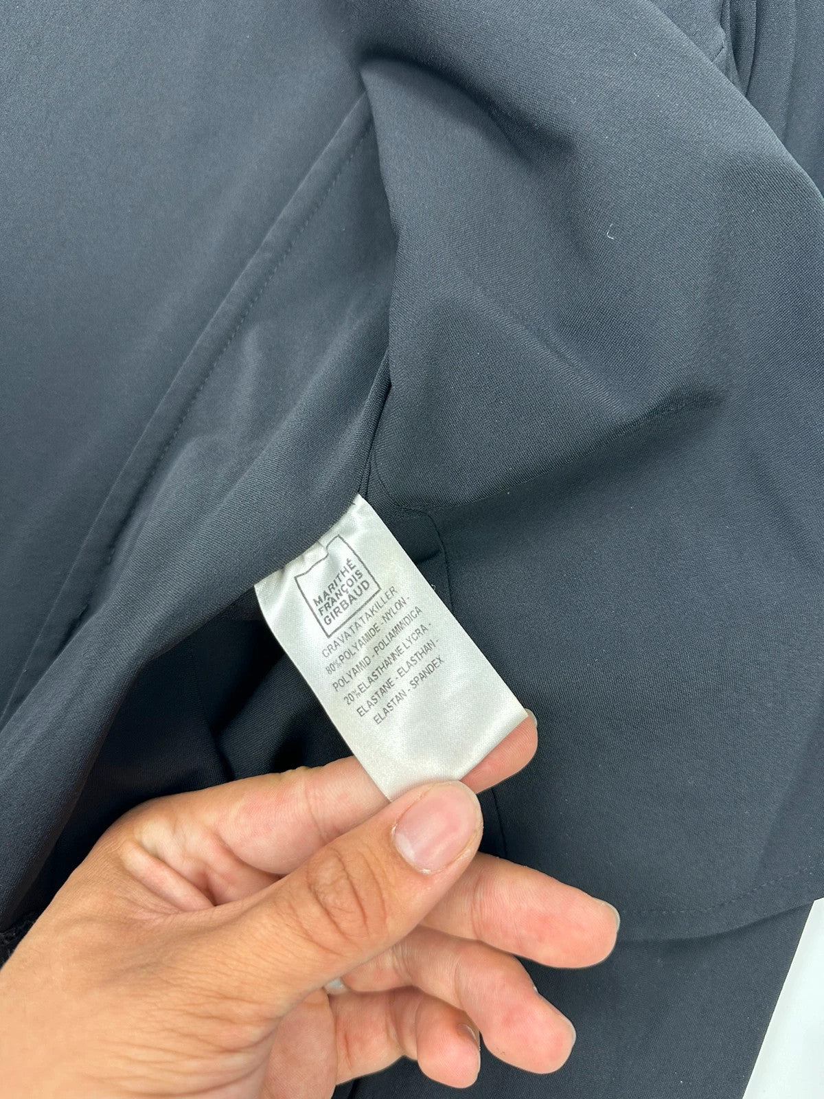 Marithé François Girbaud black fitted jacket with subtle logo detail and sleek design.