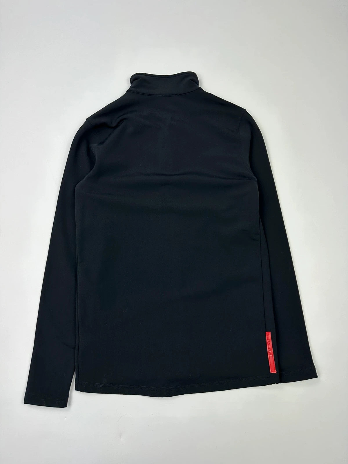 Prada black zip-up jacket featuring fleece material and iconic logo detail.