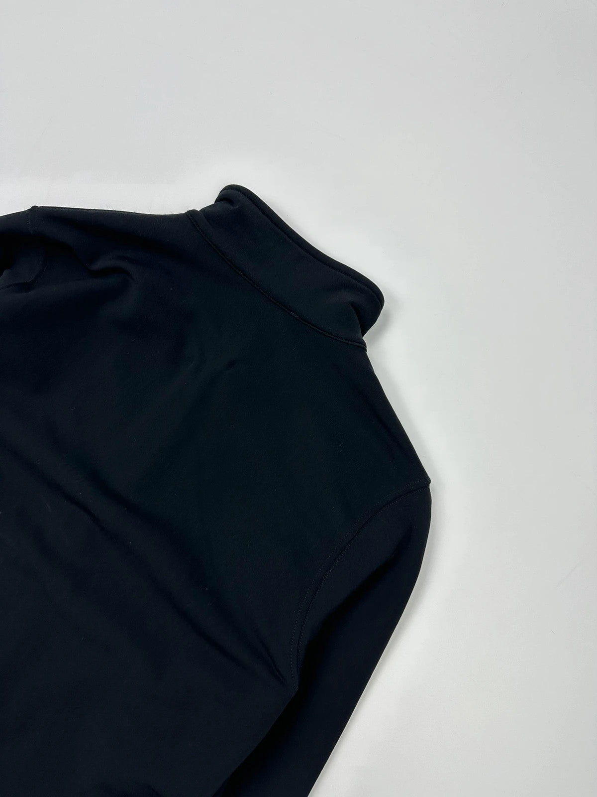 Prada black zip-up jacket featuring fleece material and iconic logo detail.