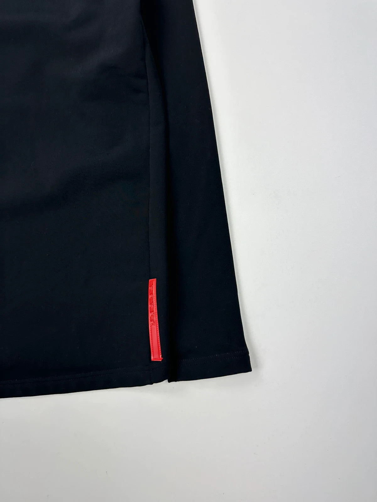 Prada black zip-up jacket featuring fleece material and iconic logo detail.
