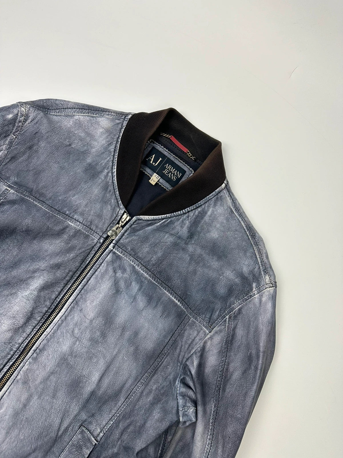 Armani blue and purple bomber jacket, eroded leather, vintage 2000s style.