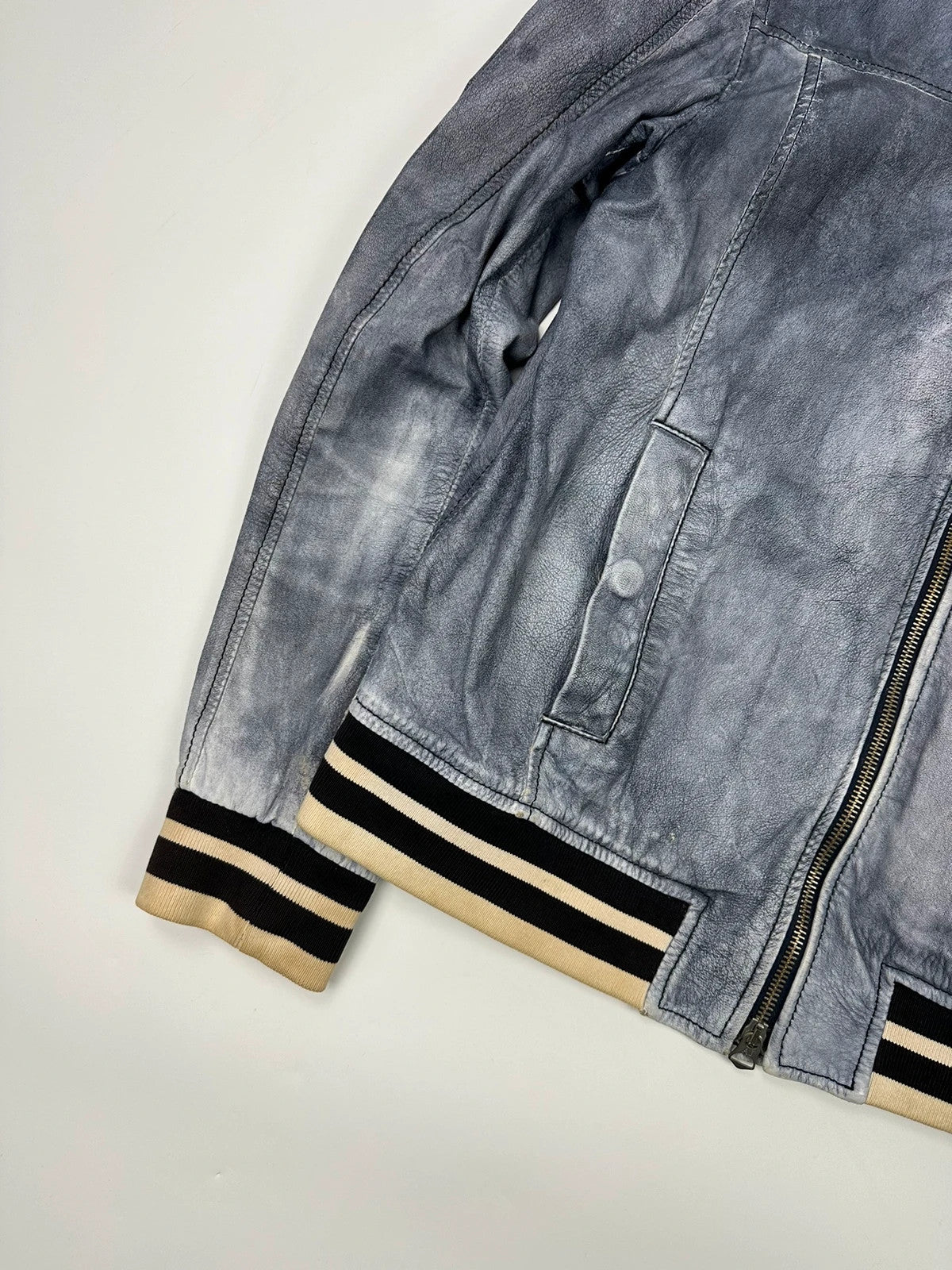 Armani blue and purple bomber jacket, eroded leather, vintage 2000s style.