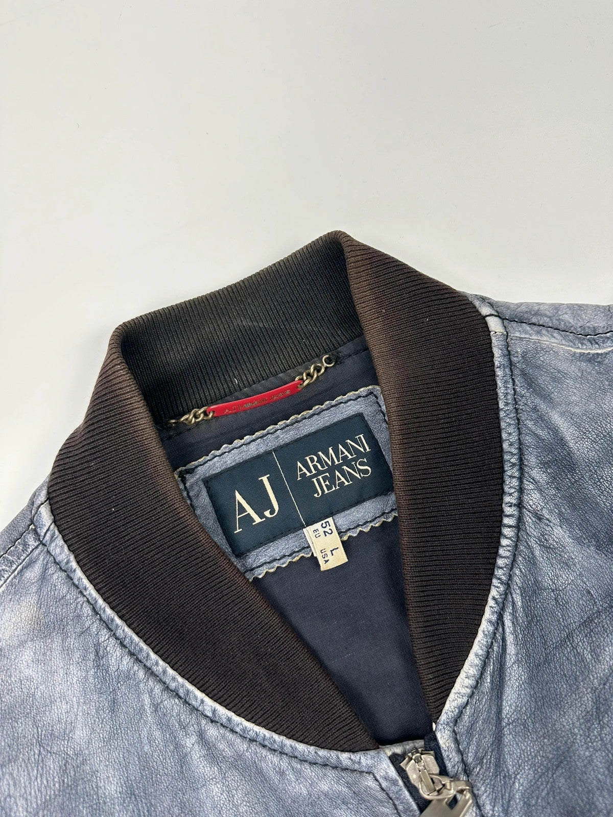 Armani blue and purple bomber jacket, eroded leather, vintage 2000s style.