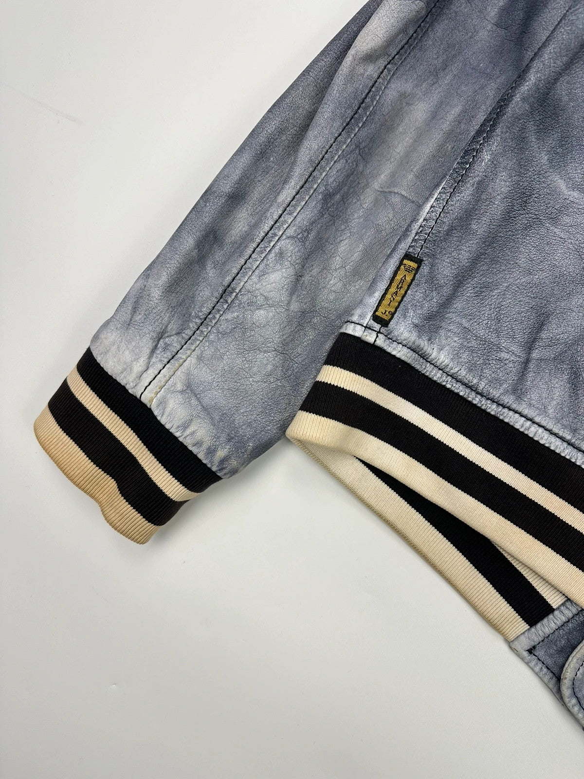 Armani blue and purple bomber jacket, eroded leather, vintage 2000s style.