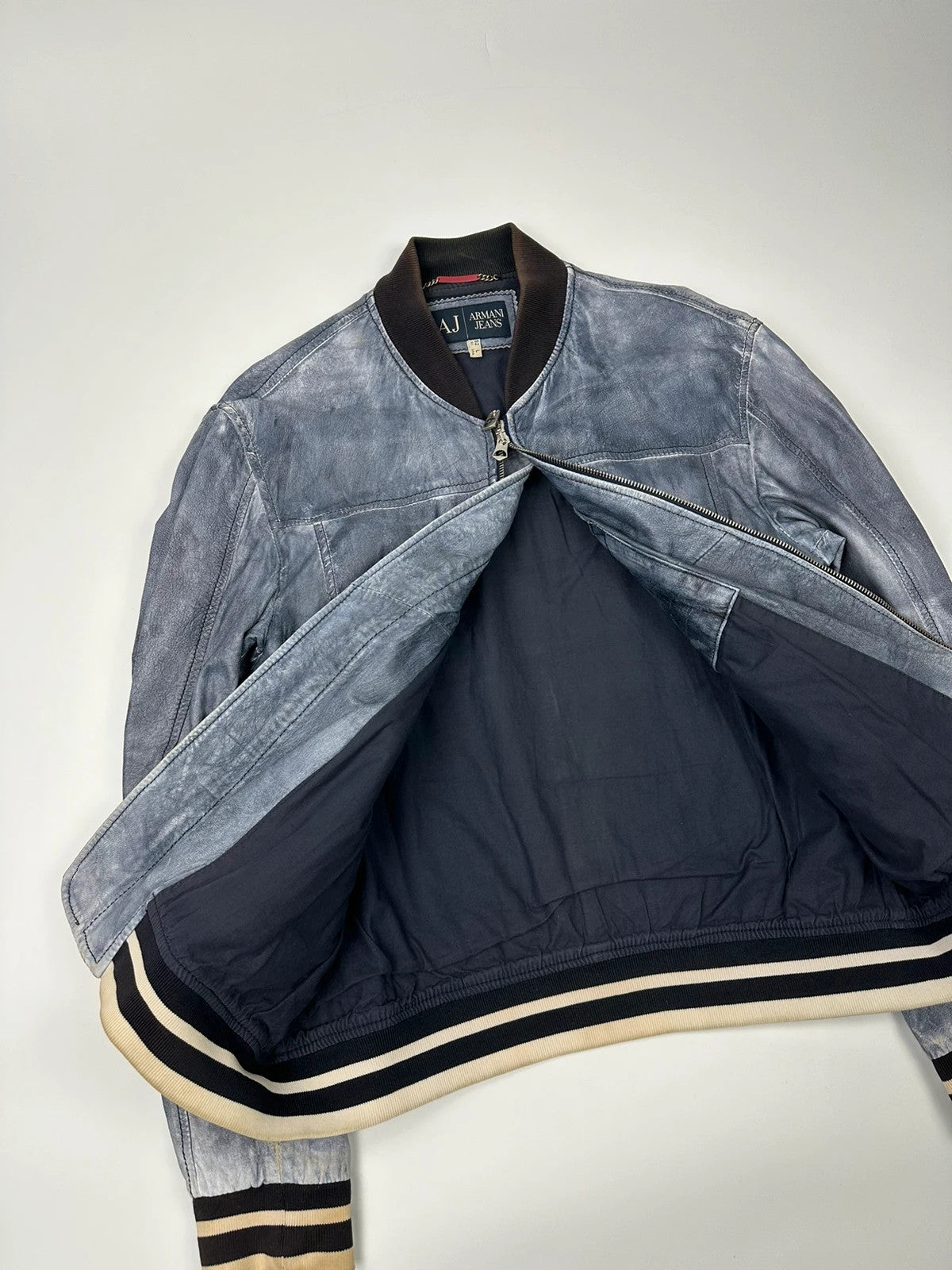 Armani blue and purple bomber jacket, eroded leather, vintage 2000s style.