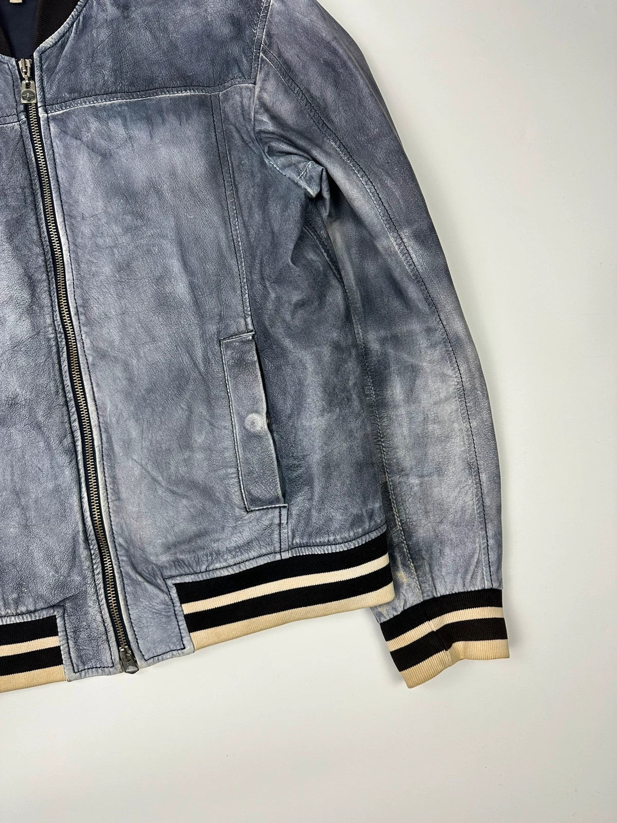 Armani blue and purple bomber jacket, eroded leather, vintage 2000s style.